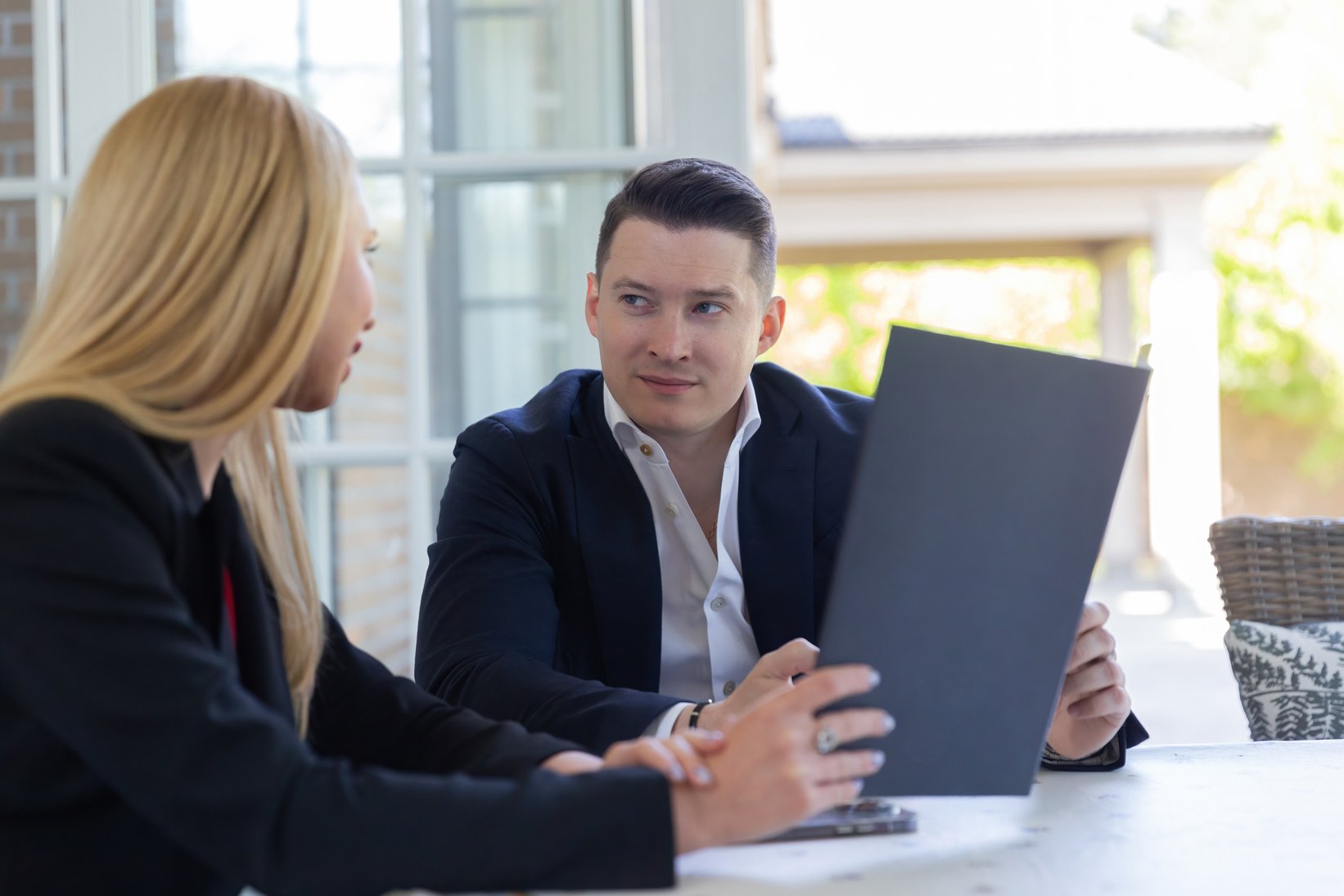 Blonde realtor presents advantages of new modern house